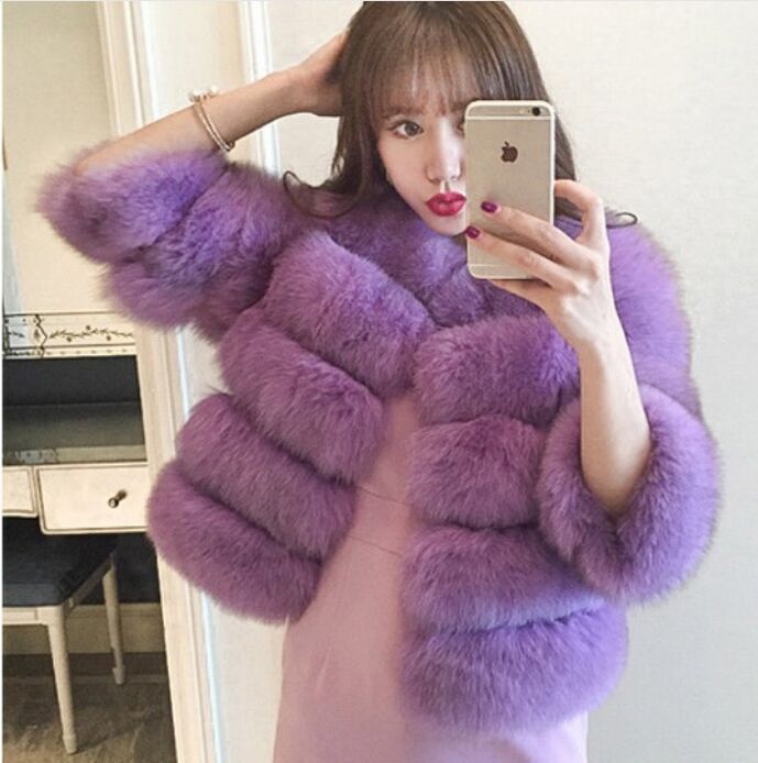 Woman wearing pink short faux fur coat with horizontal panels