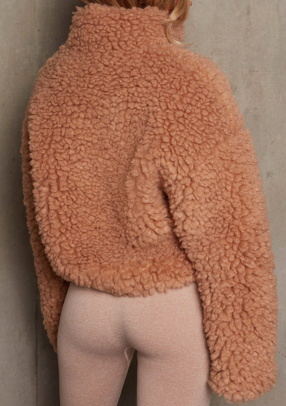 Women's short cardigan jacket on model, front view