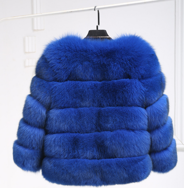 Woman wearing pink short faux fur coat with horizontal panels