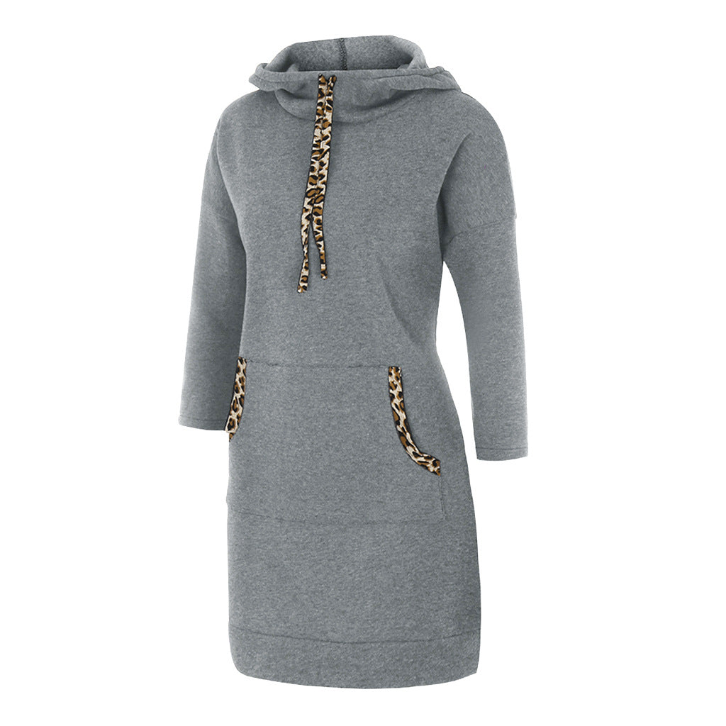Woman wearing hooded sweatshirt dress with leopard-print drawstrings