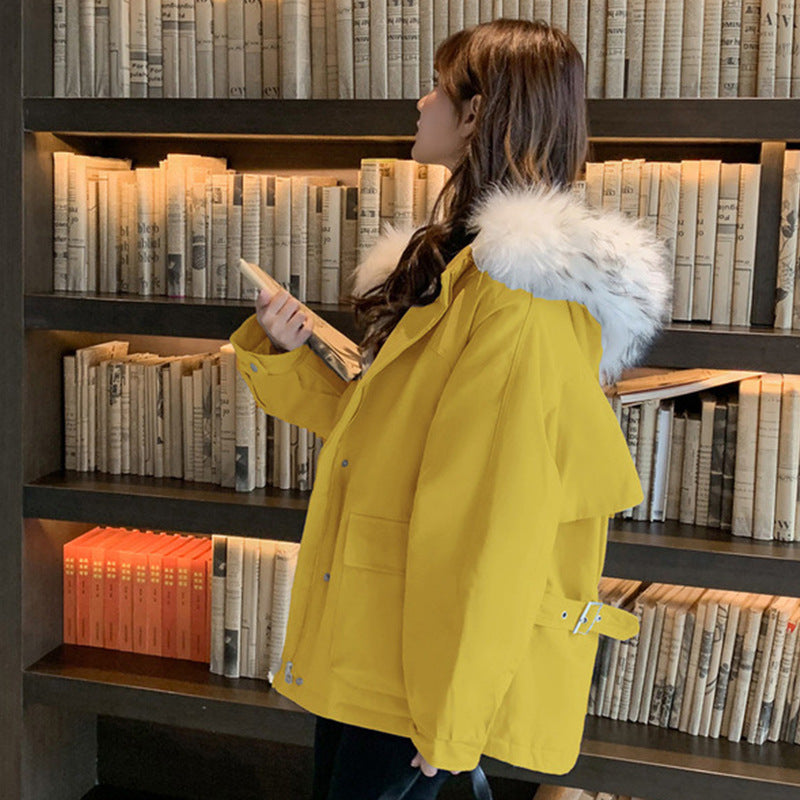 Woman wearing loose hooded winter coat in neutral tones