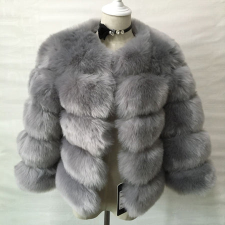 Woman wearing pink short faux fur coat with horizontal panels