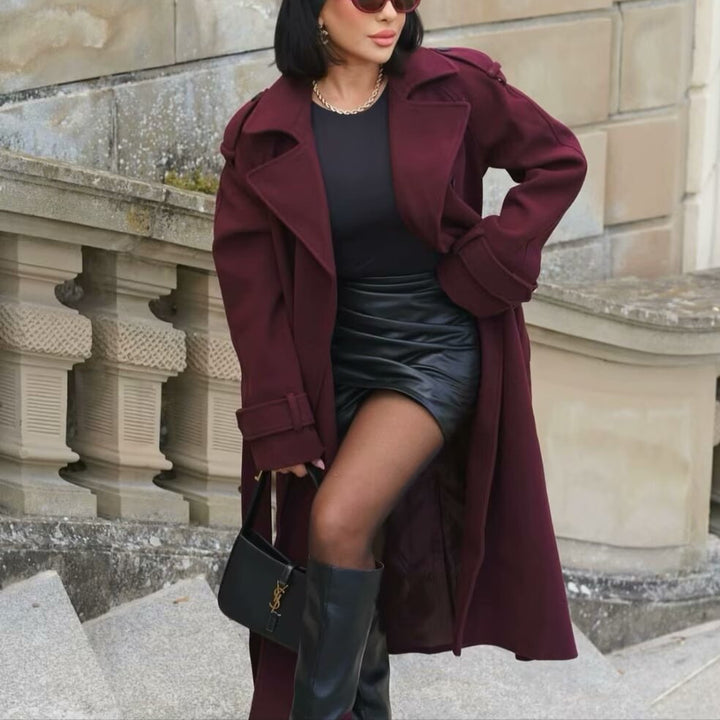 Woman wearing wine red long double-breasted trench coat with belt
