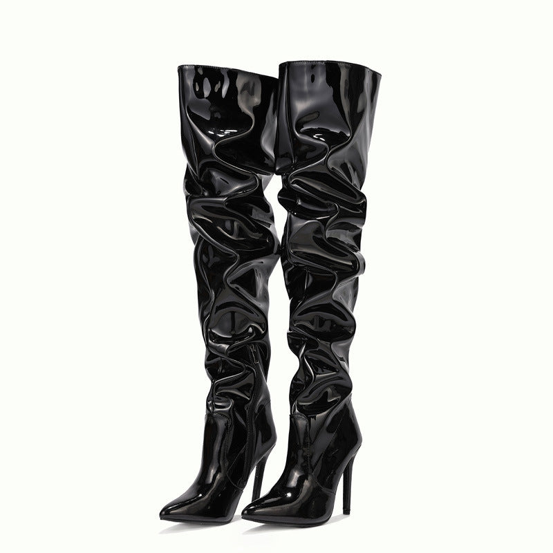 Woman wearing black knee high pointed toe heel boots