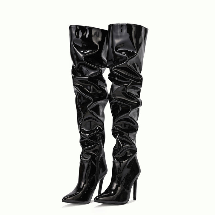 Woman wearing black knee high pointed toe heel boots