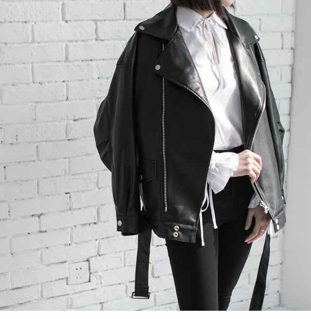 Woman wearing motorcycle jacket with belt and lapel collar
