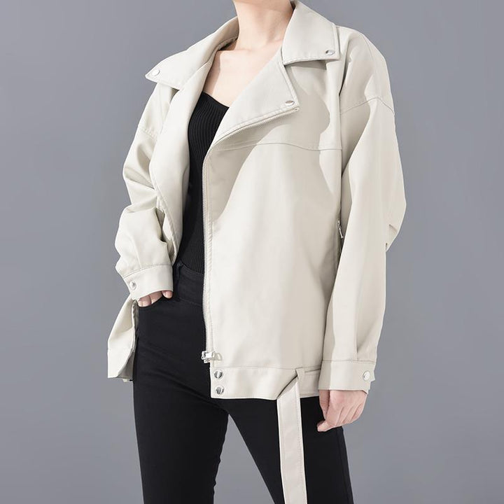 Woman wearing motorcycle jacket with belt and lapel collar