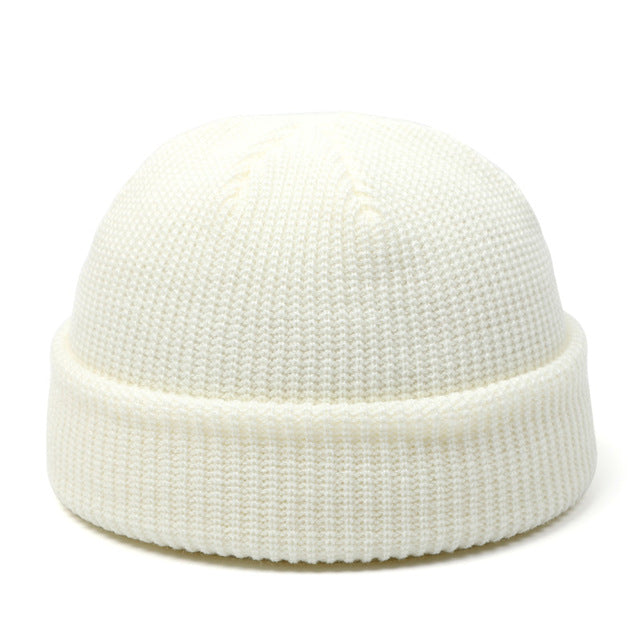 Women's black knit beanie hat on white background