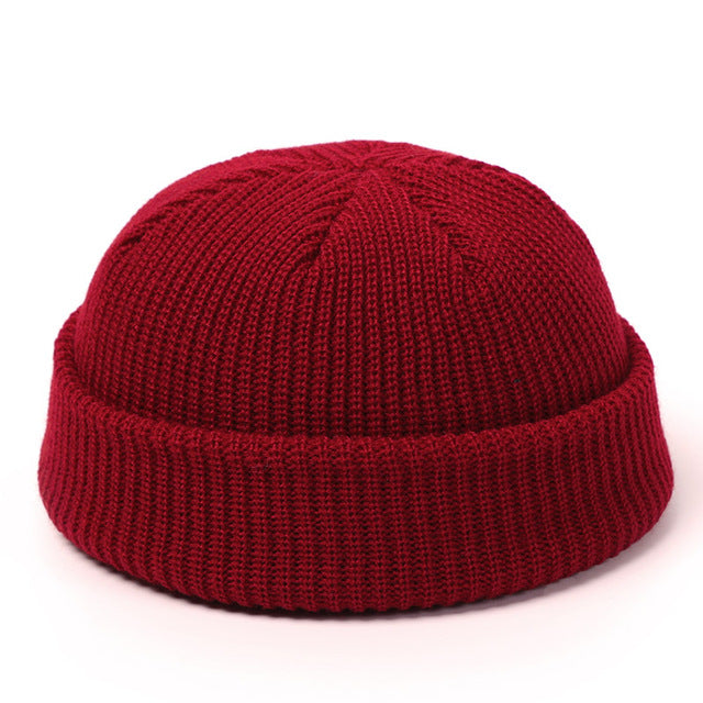 Women's black knit beanie hat on white background