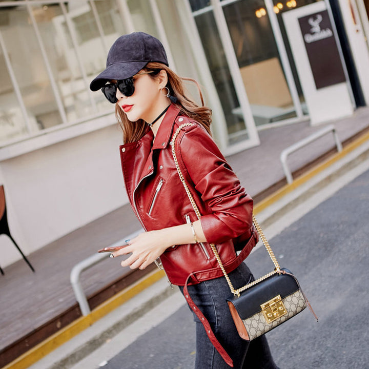 Woman wearing blue faux leather moto jacket with belt