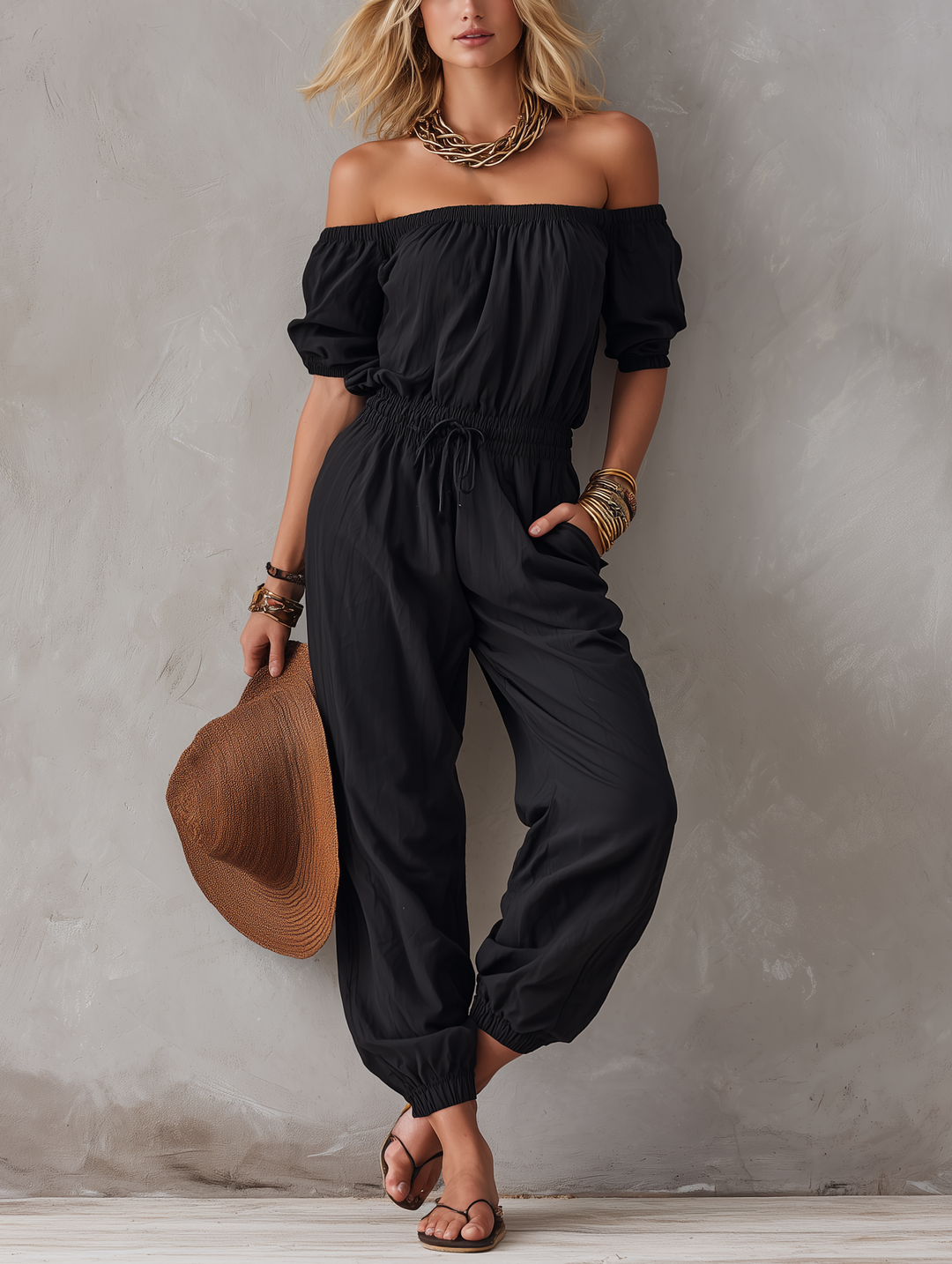 Woman wearing black off-shoulder sleeveless jumpsuit outdoors