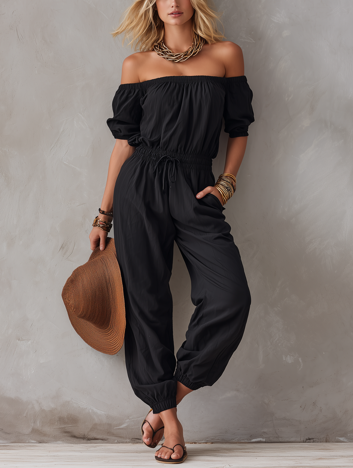 Woman wearing black off-shoulder sleeveless jumpsuit outdoors