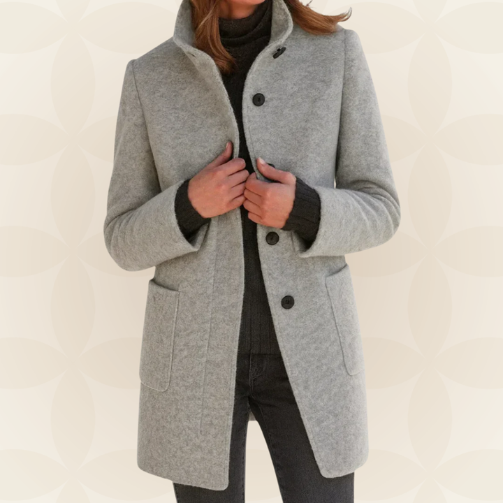 Woman wearing high collar button front coat outdoors