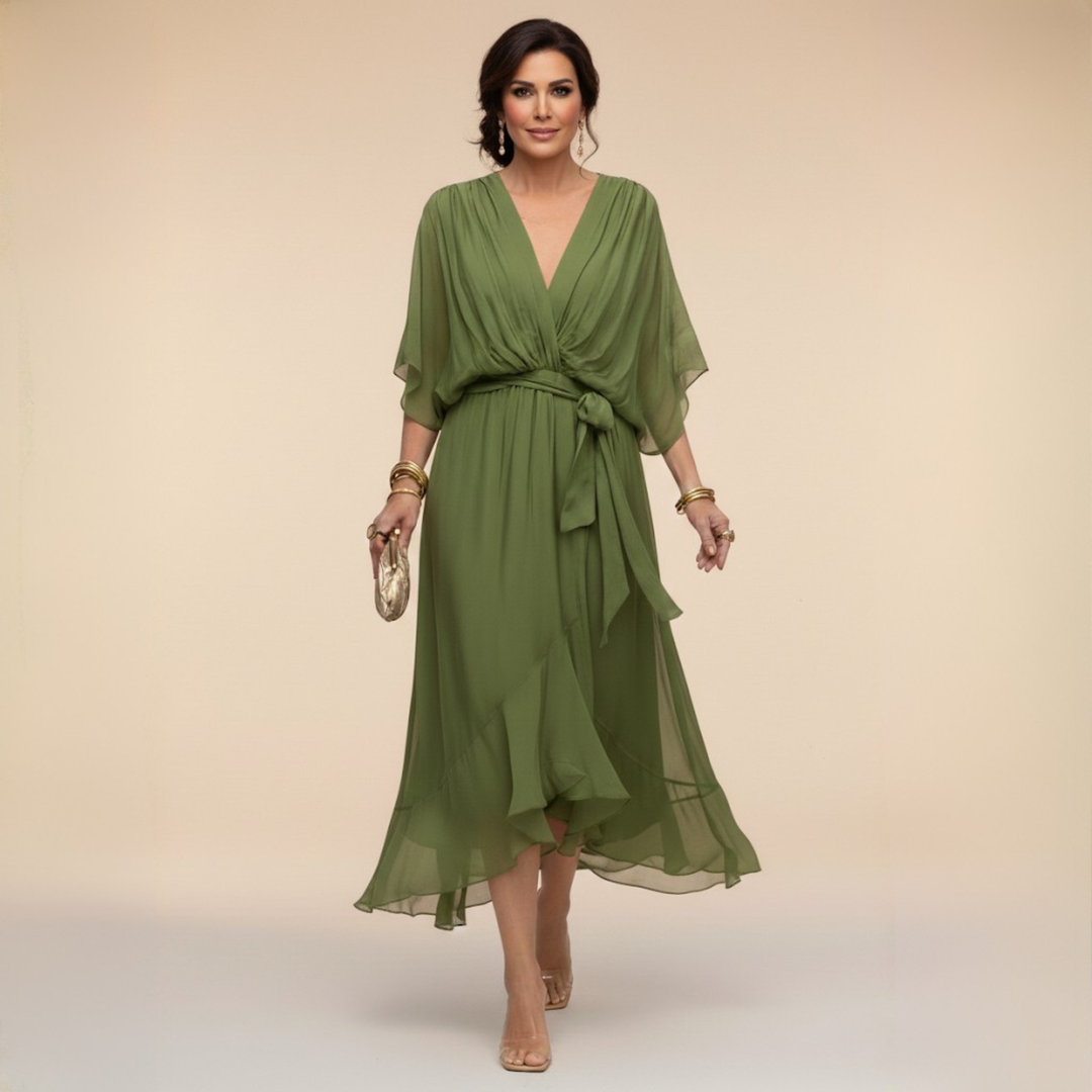 Woman wearing flowing V-neck dress in studio setting