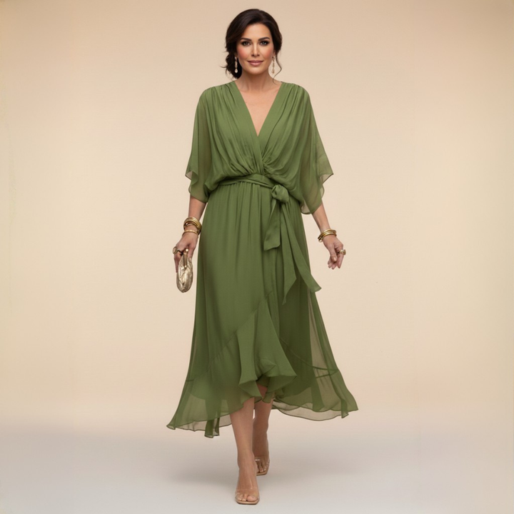 Woman wearing flowing V-neck dress in studio setting