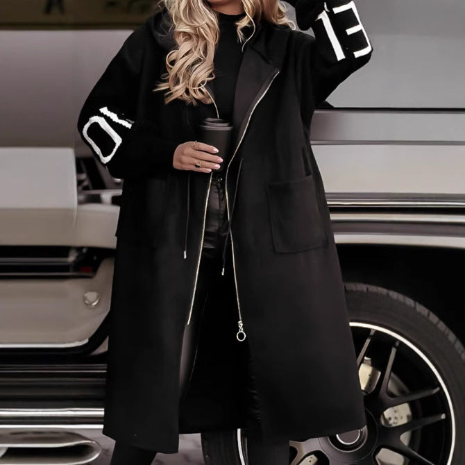 Woman wearing long hooded trench coat with drawstring detail
