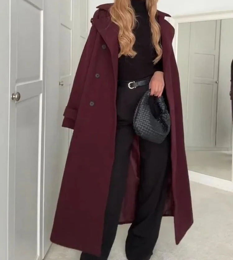 Woman wearing wine red long double-breasted trench coat with belt