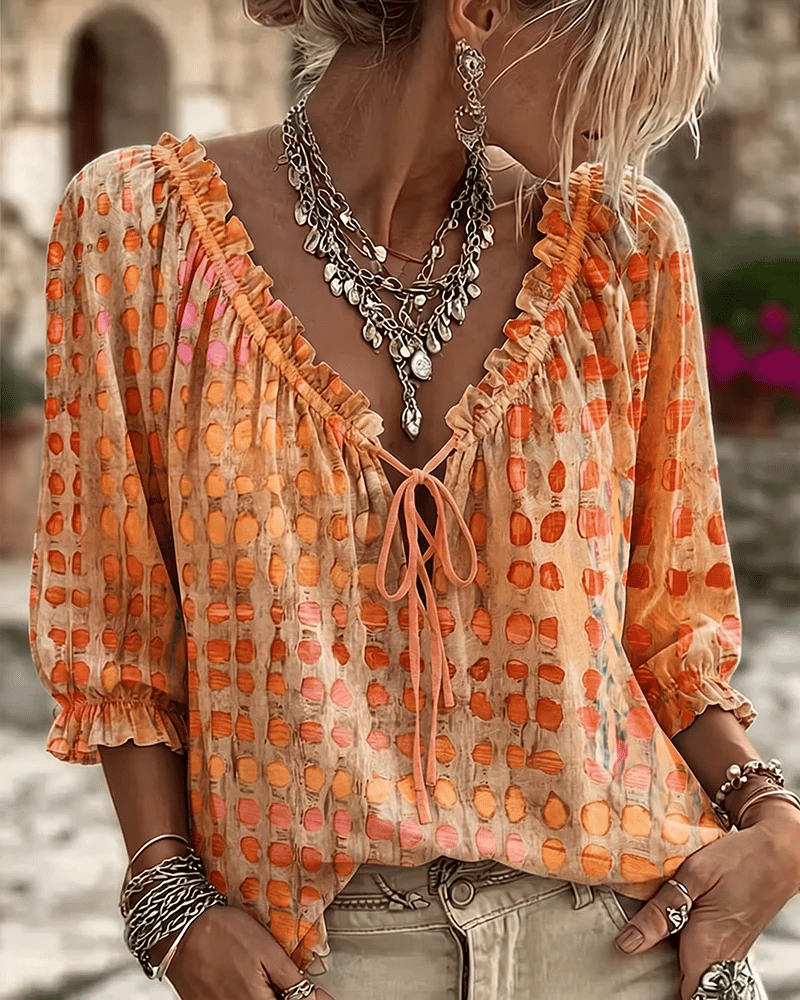 Woman wearing polka dot blouse with lace-up V-neck