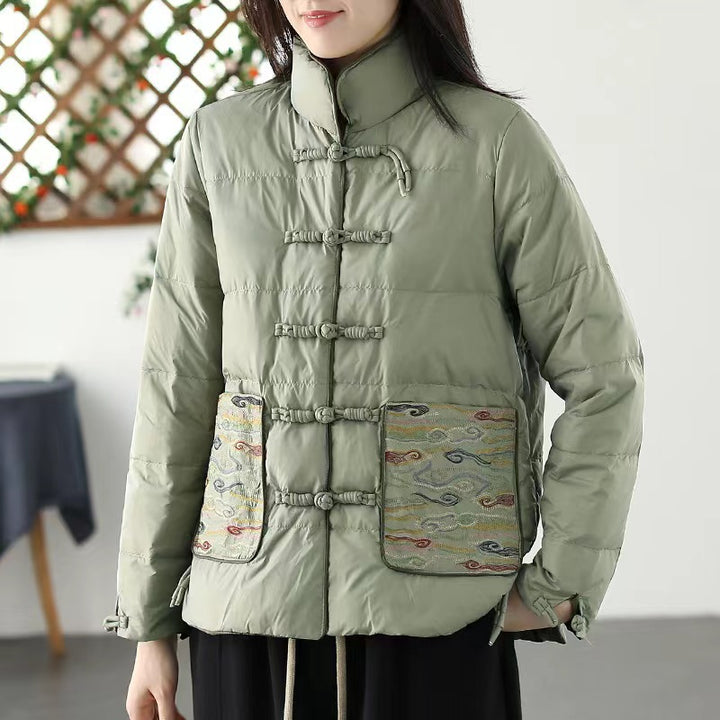 Woman wearing short embroidered down jacket with long sleeves