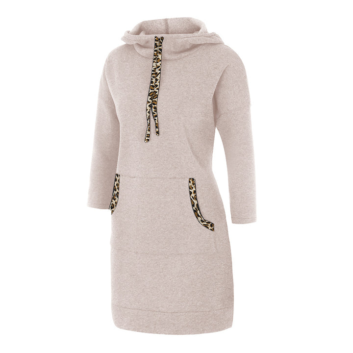 Woman wearing hooded sweatshirt dress with leopard-print drawstrings