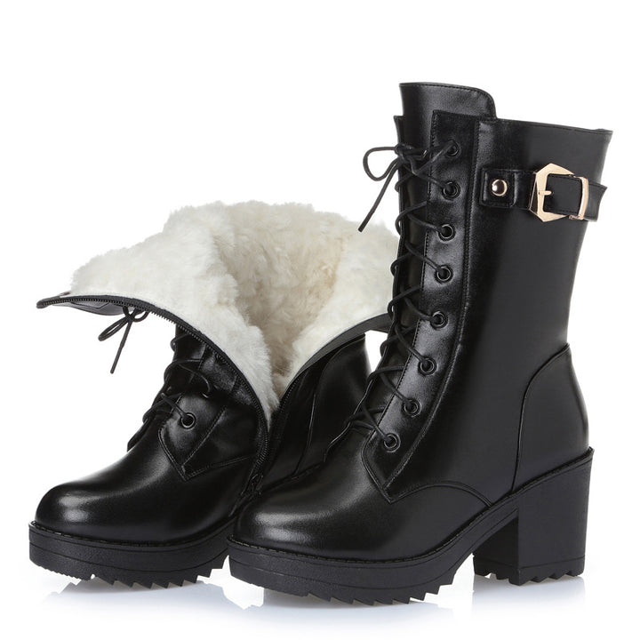 Woman wearing black leather lace-up boots with side zipper
