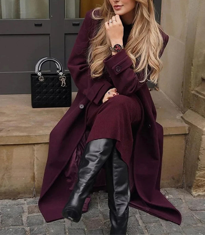 Woman wearing wine red long double-breasted trench coat with belt