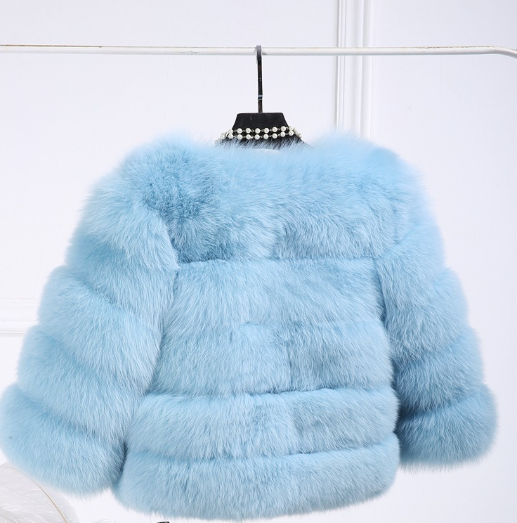 Woman wearing pink short faux fur coat with horizontal panels