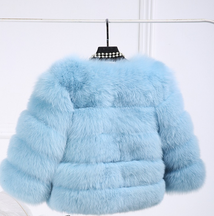 Woman wearing pink short faux fur coat with horizontal panels