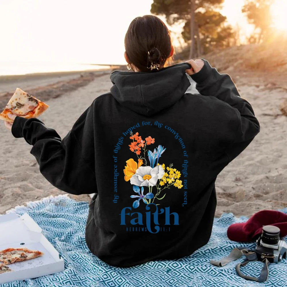 Woman wearing Bible verse graphic hoodie with long sleeves