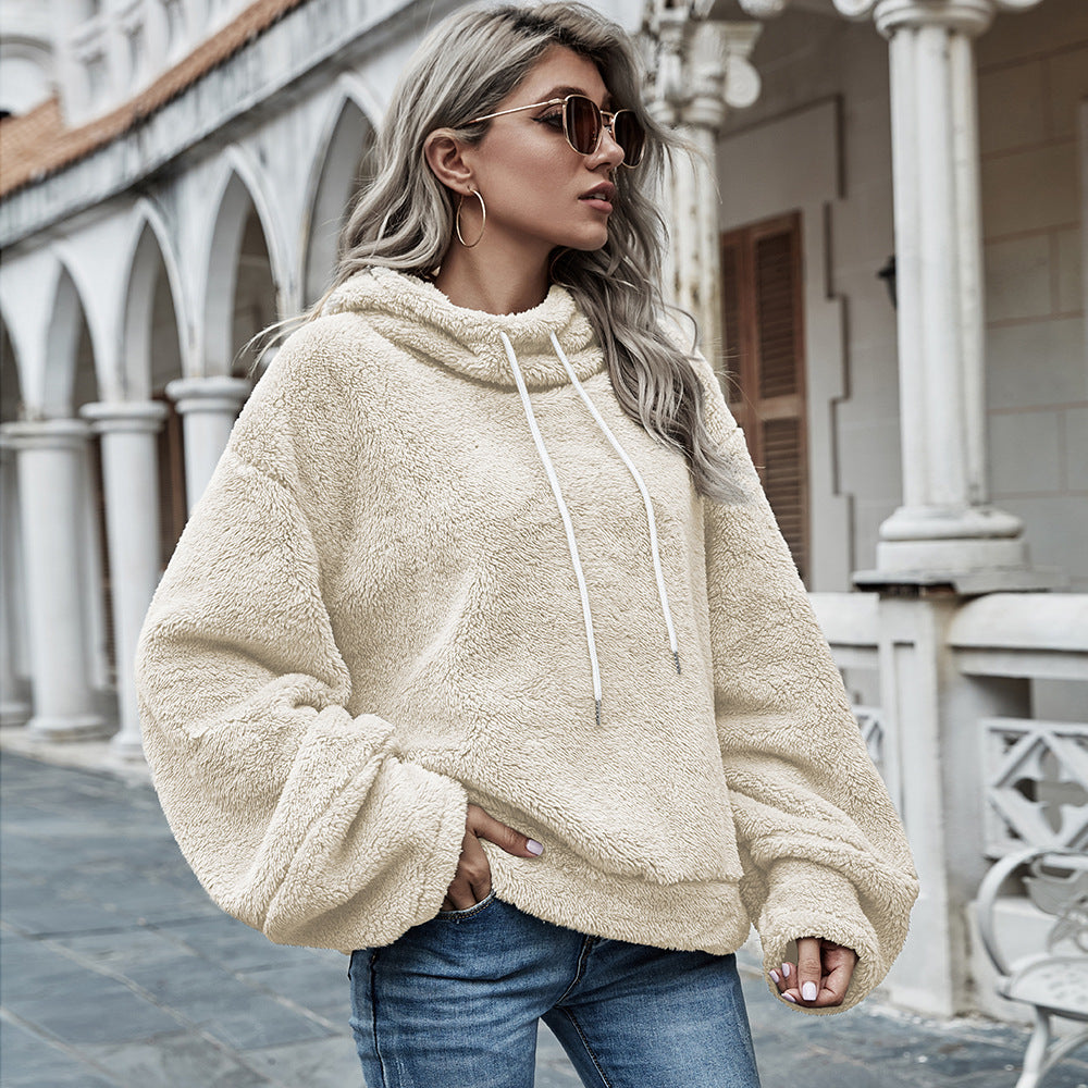 Woman wearing apricot plush hooded sweater with drawstring hood