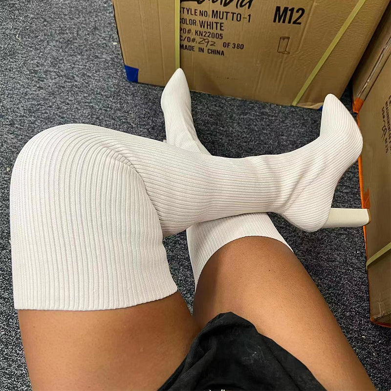 Woman wearing pointed toe over the knee high heel boots