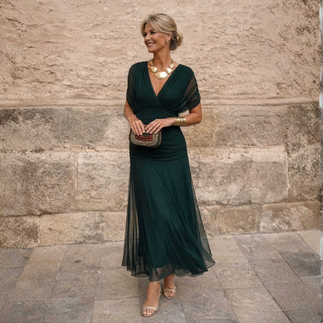 Woman wearing flowing maxi dress with crossover V-neck