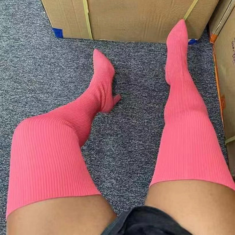 Woman wearing pointed toe over the knee high heel boots