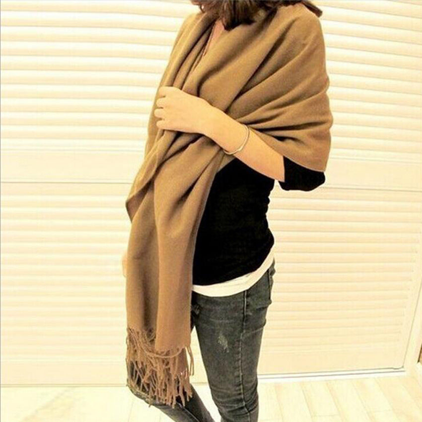 Woman wearing multi-style winter shawl scarf outdoors