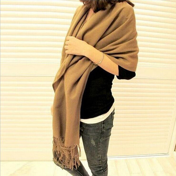 Woman wearing multi-style winter shawl scarf outdoors