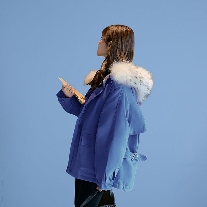 Woman wearing loose hooded winter coat in neutral tones