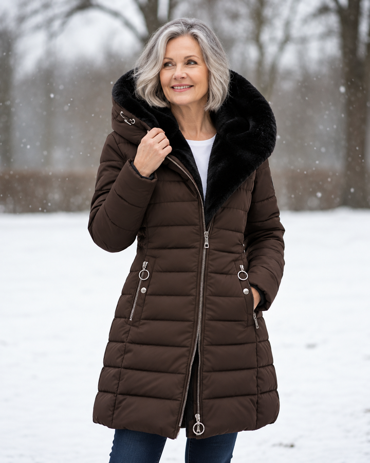 Woman wearing quilted hooded winter coat with A-line fit