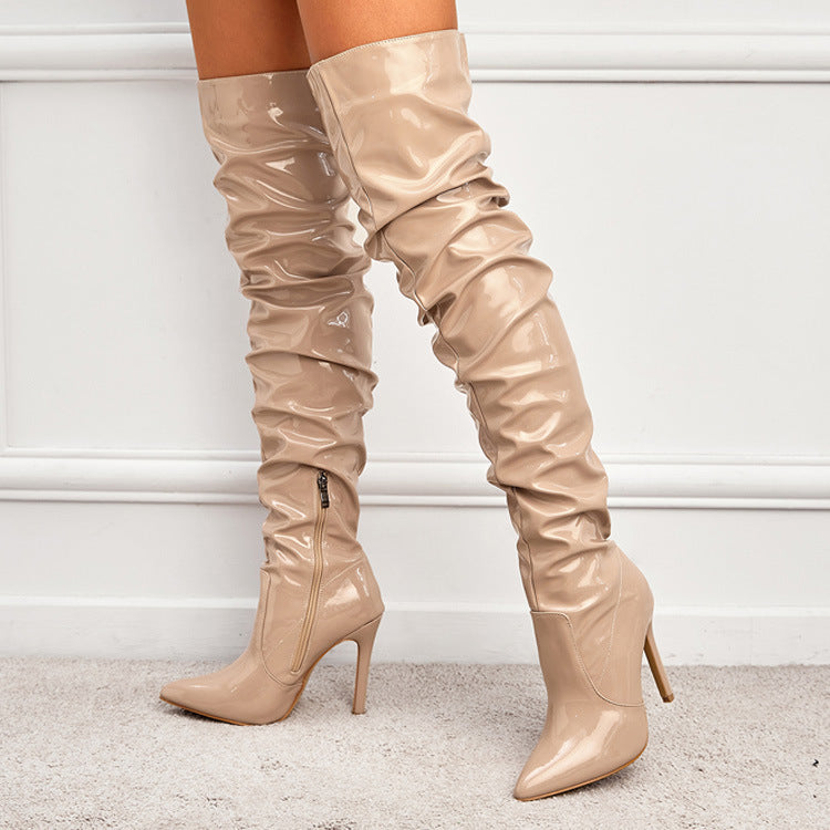 Woman wearing black knee high pointed toe heel boots