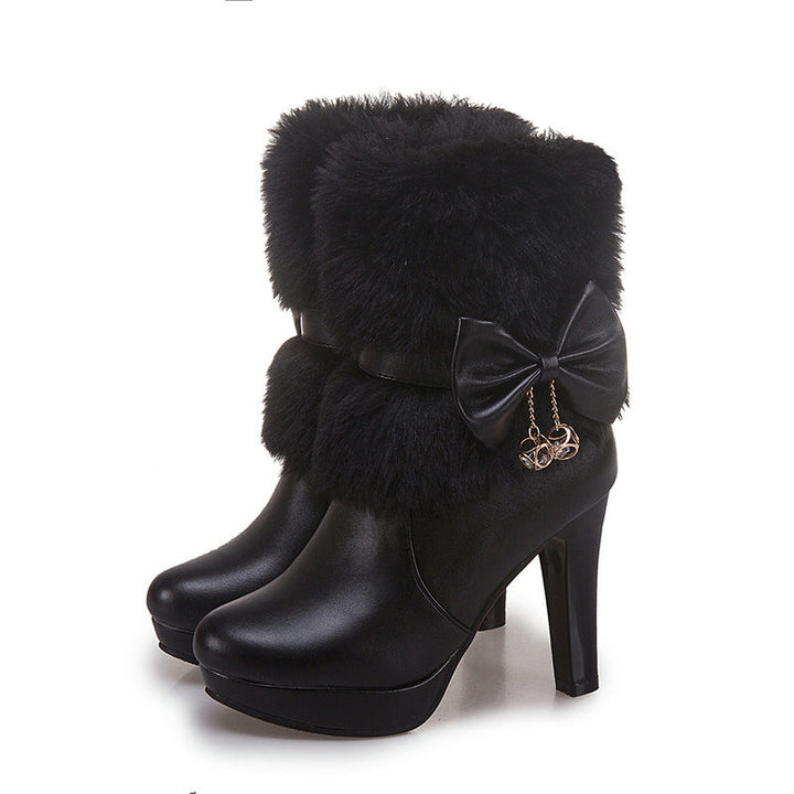 Woman wearing pink fur trim ankle boots with bow detail
