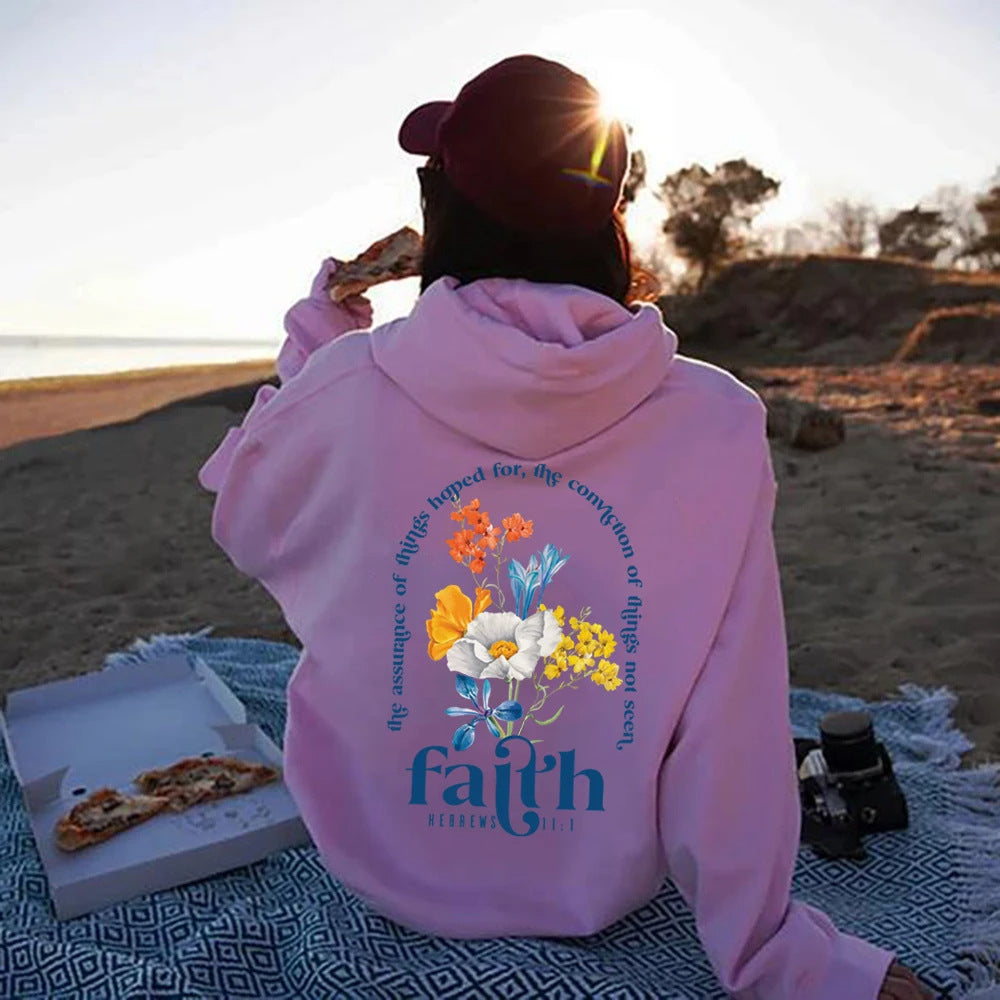 Woman wearing Bible verse graphic hoodie with long sleeves