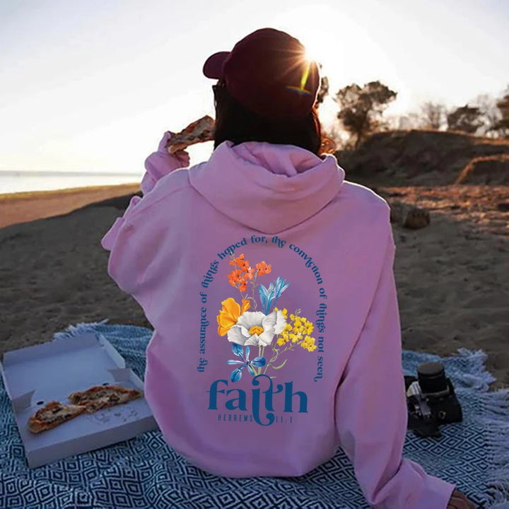 Woman wearing Bible verse graphic hoodie with long sleeves
