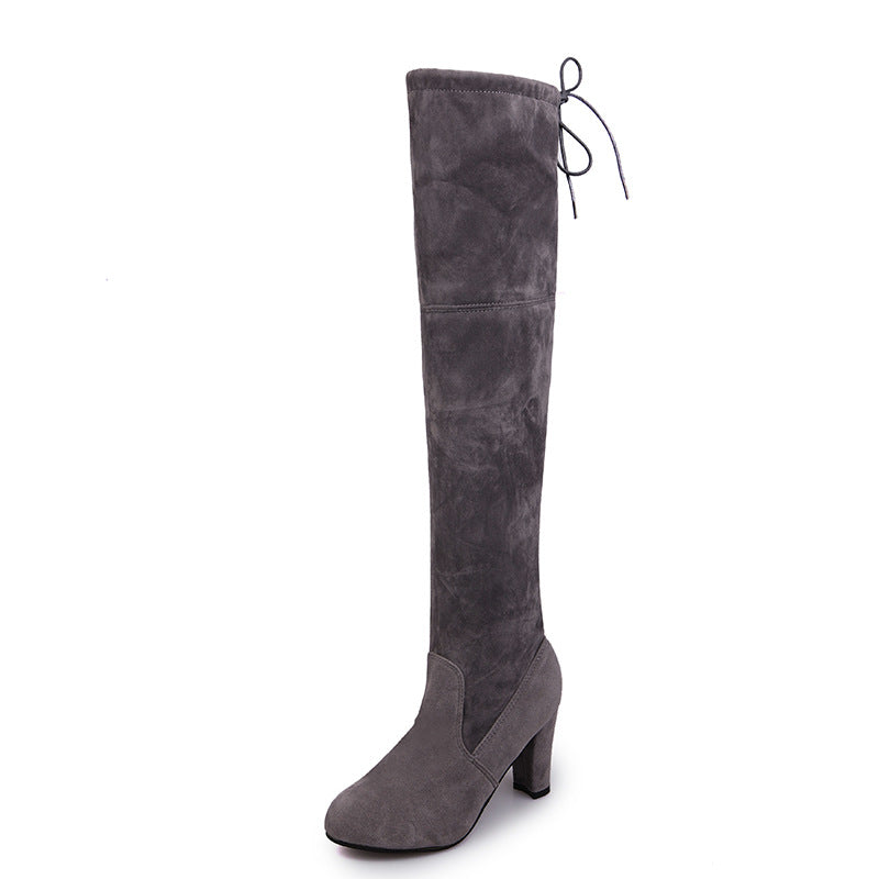 Woman wearing suede over-the-knee boots with chunky heel