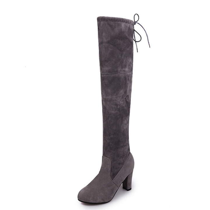 Woman wearing suede over-the-knee boots with chunky heel