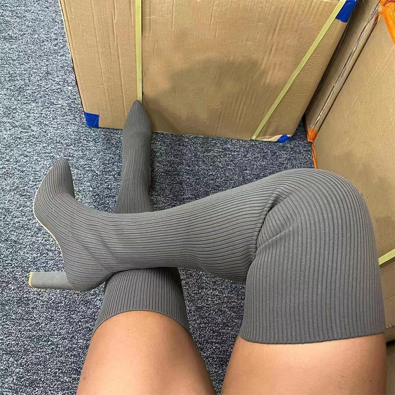 Woman wearing pointed toe over the knee high heel boots