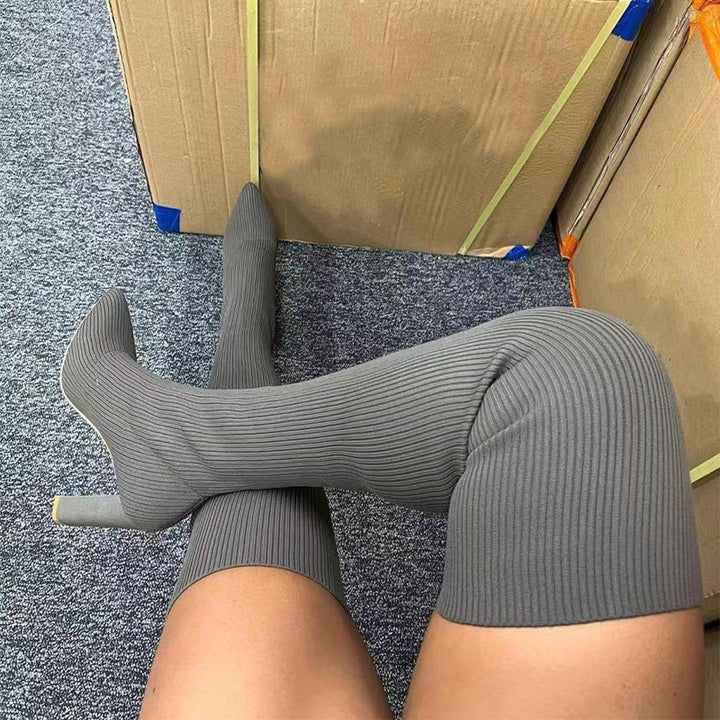 Woman wearing pointed toe over the knee high heel boots