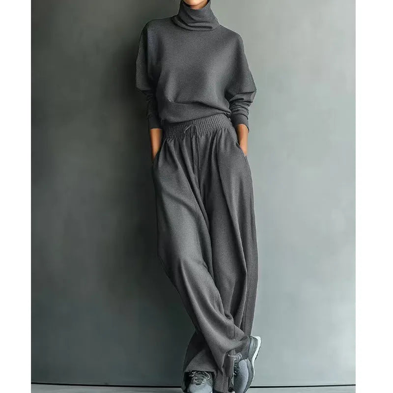 Woman wearing black turtleneck two-piece set with wide-leg trousers