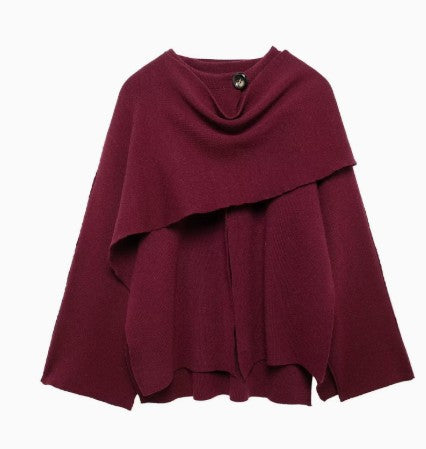 Woman wearing knit cardigan coat with asymmetric scarf detail