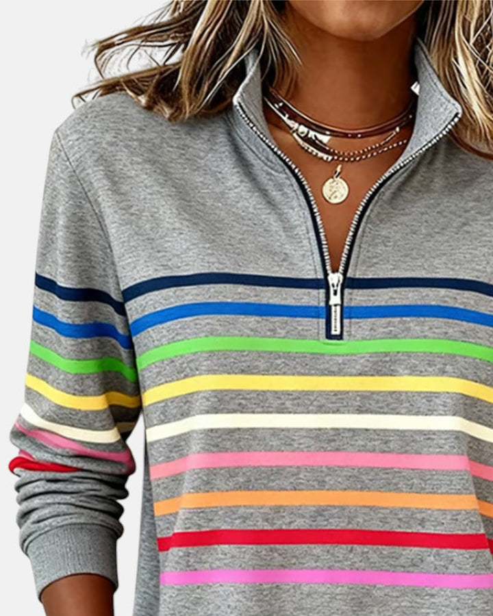 Woman wearing rainbow striped half zip sweatshirt