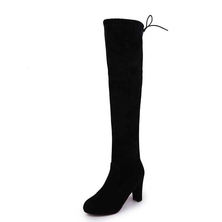 Woman wearing suede over-the-knee boots with chunky heel