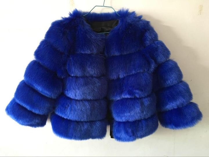 Woman wearing pink short faux fur coat with horizontal panels